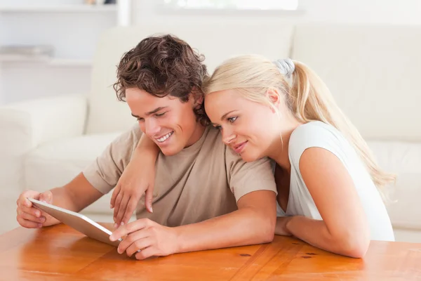 Hugging couple with a tablet — Stock Photo, Image
