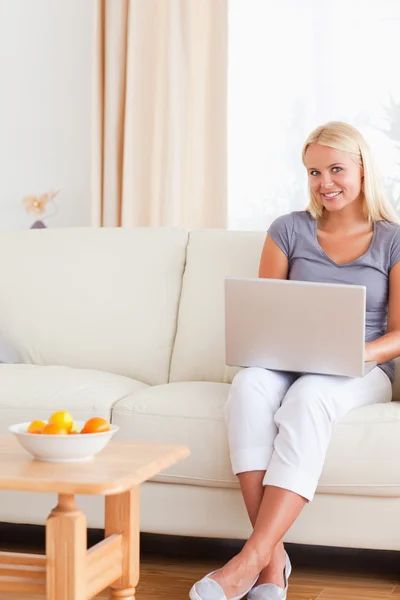 Portrait of a relaxed woman holding a laptop — Stock Photo, Image