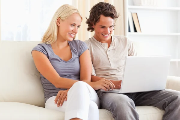 Sorrindo no casal de amor usando um laptop — Fotografia de Stock