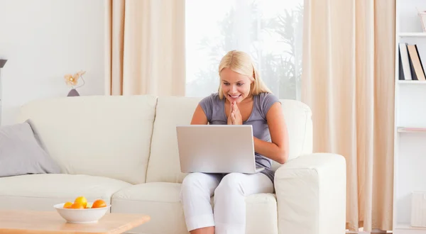 Excited woman using her laptop — Stock Photo, Image