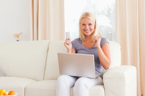 Woman cheering while buying online — Stock Photo, Image