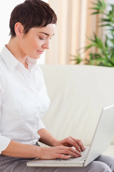 Brunette woman with a laptop — Stock Photo, Image