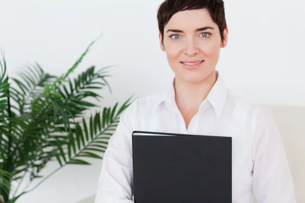 Portrait of a Brunette short-haired woman with a folder — Stock Photo, Image