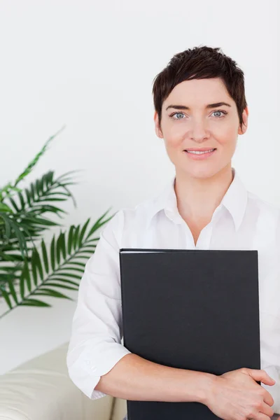 Portrait of a Brunette woman with a folder — Stock Photo, Image