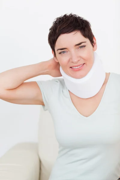Close up of a brunette woman with a surgical collar — Stock Photo, Image
