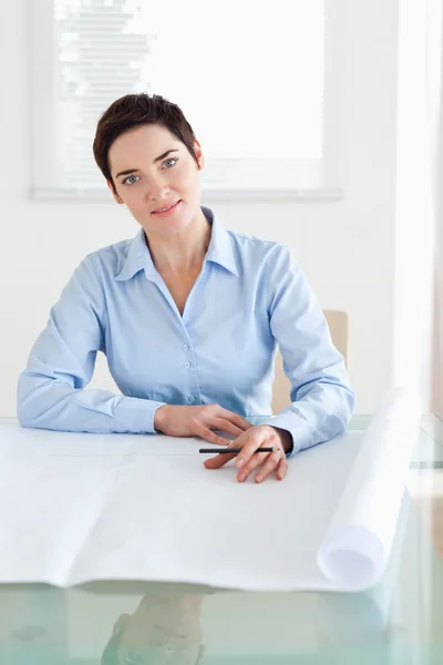 Working brunette businesswoman with a architectural plan — Stock Photo, Image