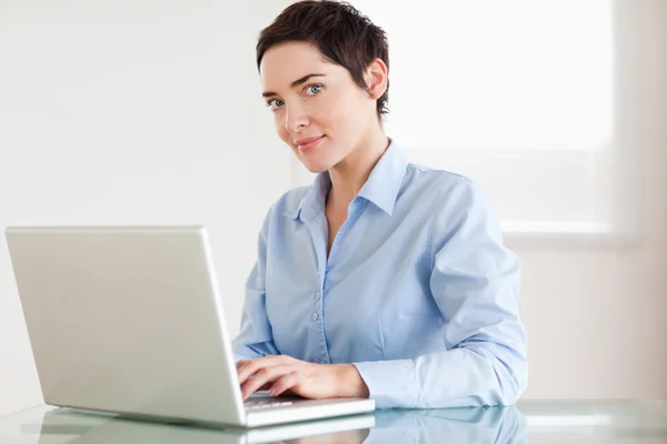 Charming businesswoman with a laptop — Stock Photo, Image