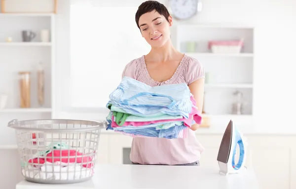 Joyful Woman with a pile of clothes — Stock Photo, Image