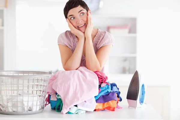 Cheerful Woman with a pile of clothes — Stock Photo, Image