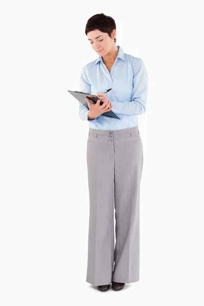 Woman writing on a clipboard — Stock Photo, Image