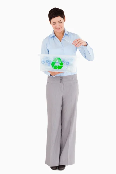 Žena dát prázdnou plastovou láhev v recyklační box — Stock fotografie