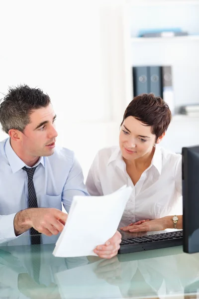 Portrait of coworkers talking about a document — Stock Photo, Image