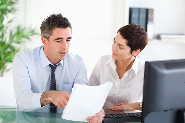 Coworkers looking at a document — Stock Photo, Image