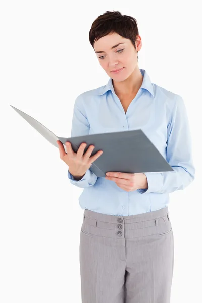 Portrait of a businesswoman looking at a binder — Stock Photo, Image