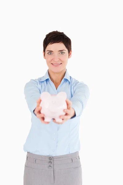 Office worker holding a piggy bank — Stock Photo, Image