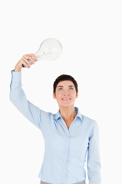 Businesswoman holding a light bulb — Stock Photo, Image