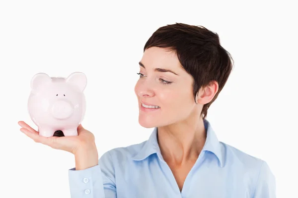 Close up of an office worker holding a piggy bank — Stock Photo, Image