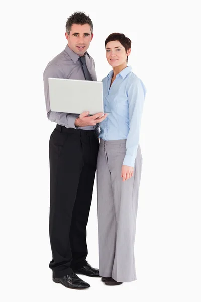 Office workers holding a laptop — Stock Photo, Image