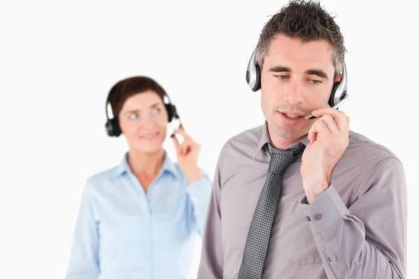 Office workers speaking through headsets — Stock Photo, Image