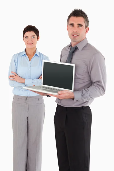 Portrait of a man showing a notebook while his colleague is posi — Stock Photo, Image