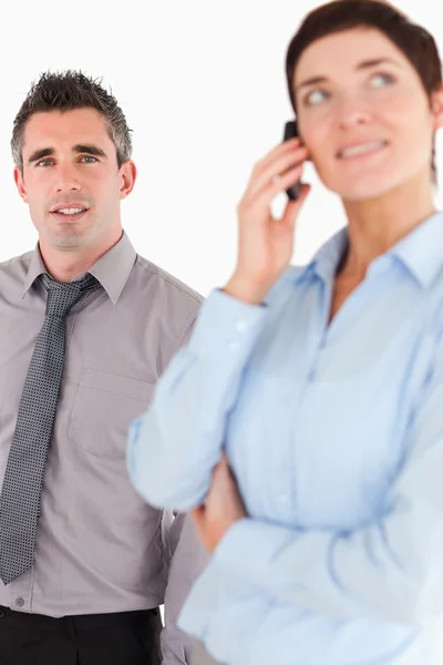 Portrait of a woman on the phone call while her coworker is posi — Stock Photo, Image