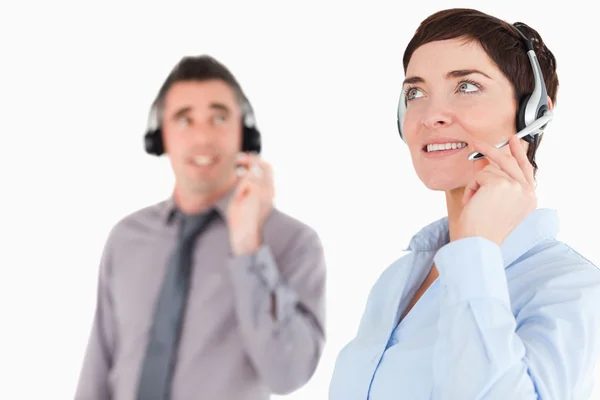 Close up of colleagues using headsets — Stock Photo, Image