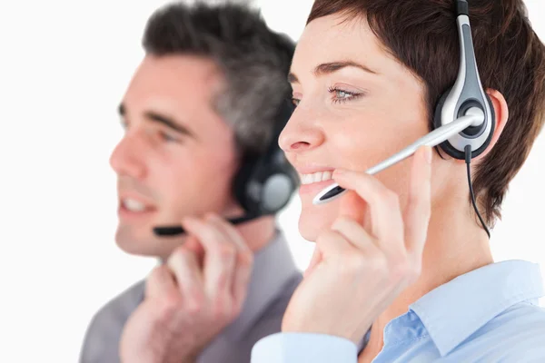 Close up of operators speaking through headsets — Stock Photo, Image