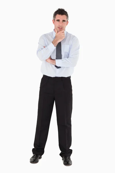 Businessman with his hand on his chin — Stock Photo, Image