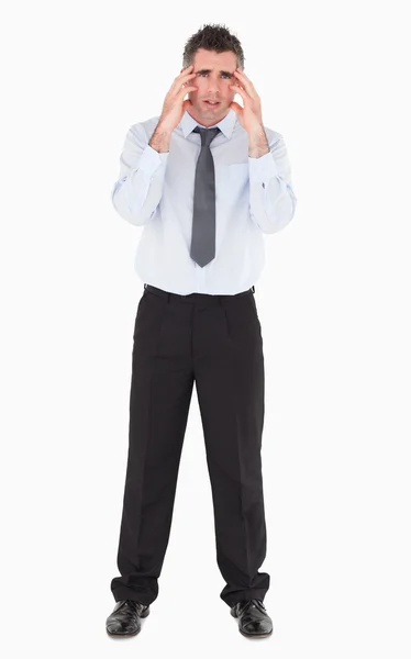 Sad businessman with his hands on his temples — Stock Photo, Image