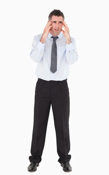 Depressed businessman with his hands on his temples — Stock Photo, Image