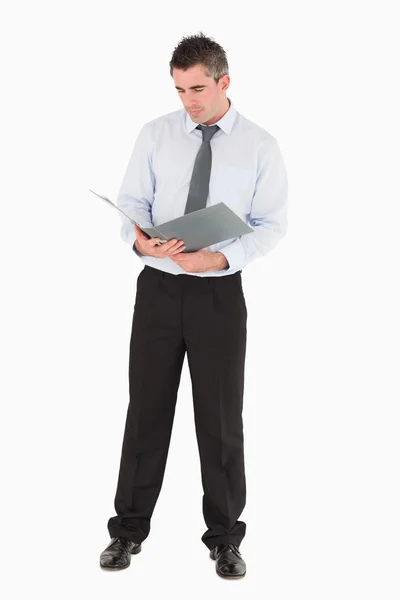 Businessman looking at a binder — Stock Photo, Image