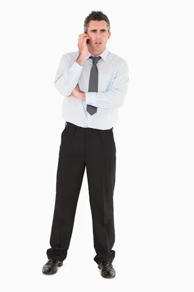 Angry businessman using a mobile phone — Stock Photo, Image