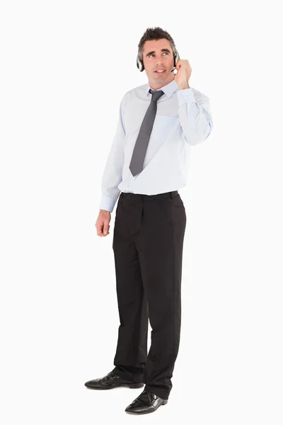 Trabalhador de escritório posando com um fone de ouvido — Fotografia de Stock