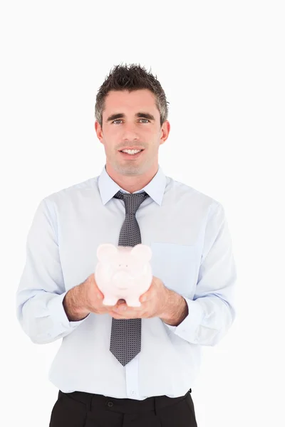 Man showing a piggy bank — Stock Photo, Image