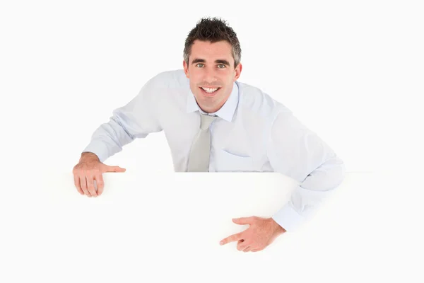 Businessman pointing at blank panel — Stock Photo, Image