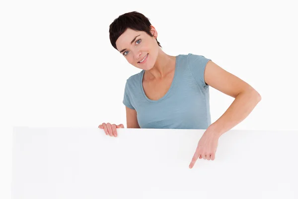 Woman pointing at something on a panel — Stock Photo, Image