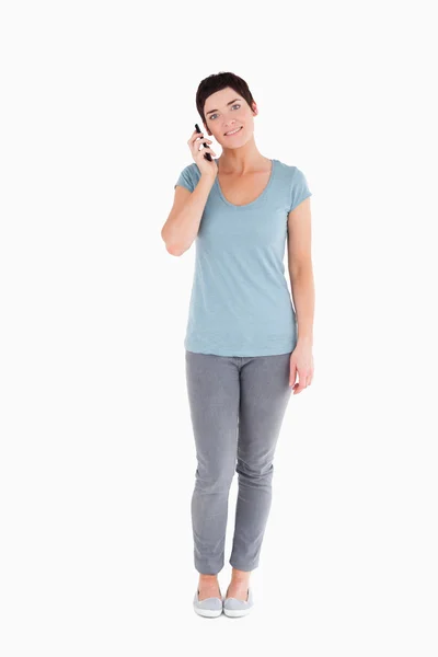 Usmívající se žena volá mobilním telefonem携帯電話を呼び出す女性の笑みを浮かべてください。 — Stock fotografie