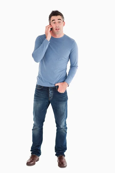 Surprised man answering the phone — Stock Photo, Image
