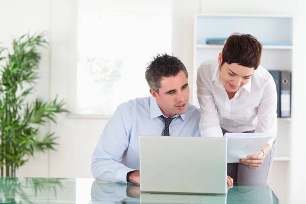 Colleagues comparing a blueprint document to an electronic one — Stock Photo, Image