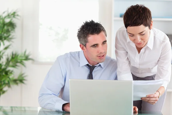 Coworkers comparing a blueprint document to an electronic one — Stock Photo, Image