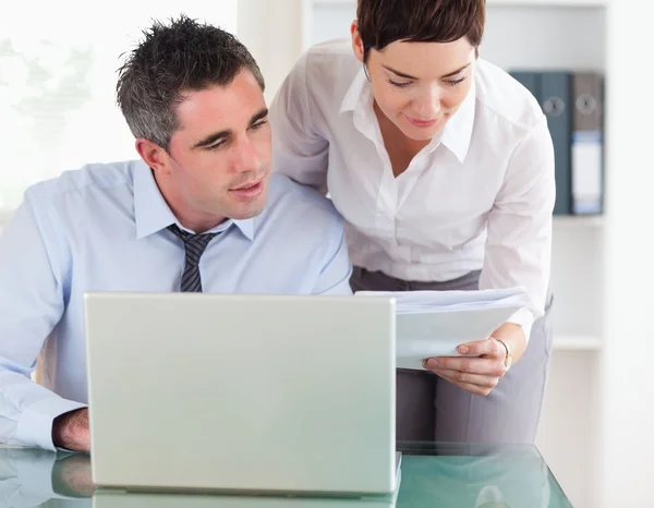 Colleagues comparing a blueprint folder to an electronic one — Stock Photo, Image