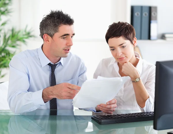 Man pointing at something to his colleague on a document — Stock Photo, Image