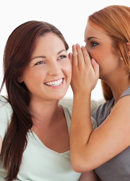 Brunette woman being told a secret — Stock Photo, Image