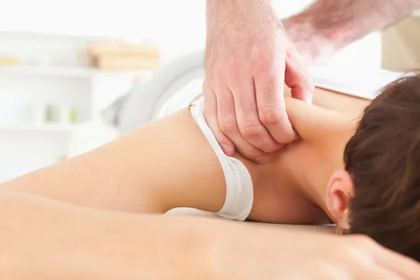 Morena Mujer recibiendo un masaje en el cuello —  Fotos de Stock