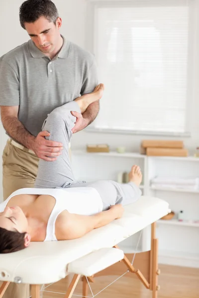 Chiropractor and patient doing exercises — Stock Photo, Image
