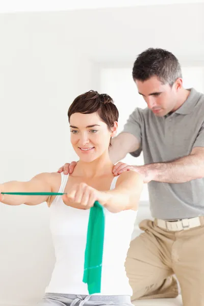 Patient doing some exercises under supervision — Stock Photo, Image