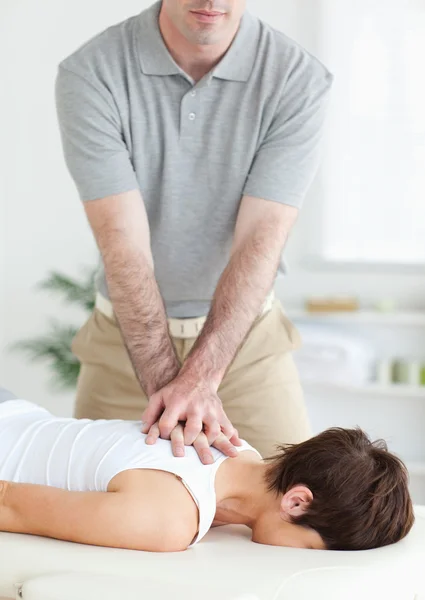 Handsome Man massaging a cute woman's neck — Stock Photo, Image