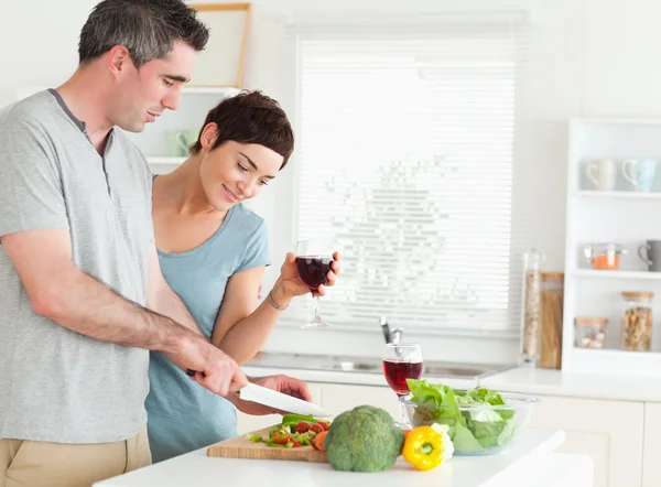 Couple with wine and vegetables — Stock Photo, Image