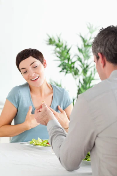 Man proposing to his amazed girlfriend during dinner — Stock Photo, Image