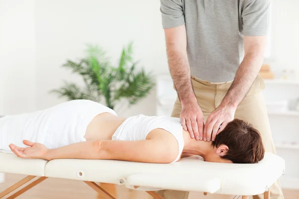 Guy massageando o pescoço de uma mulher morena — Fotografia de Stock